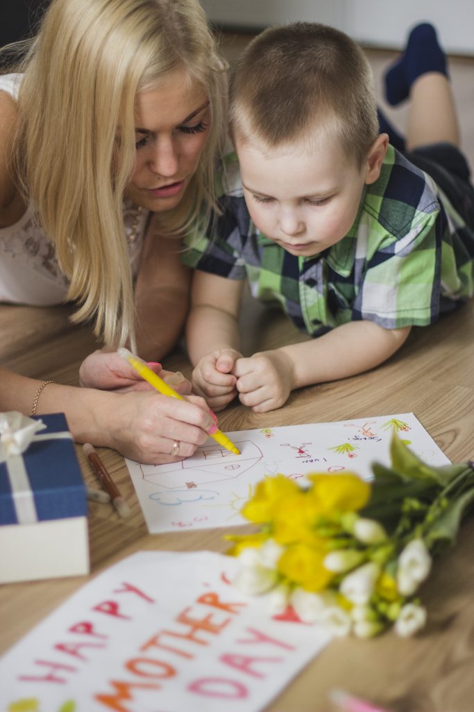 Mother helps child with impulse control strategies by making a visual aid.