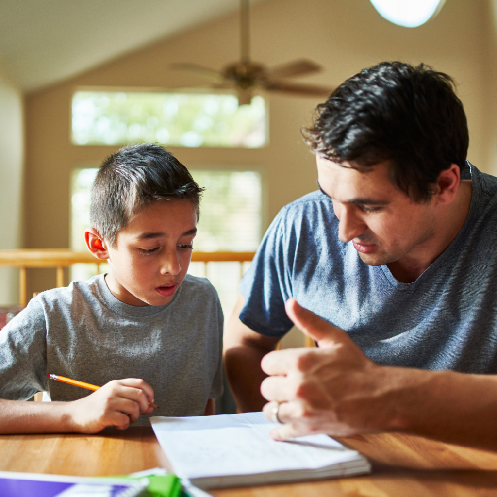 Father and son work on math homework together.