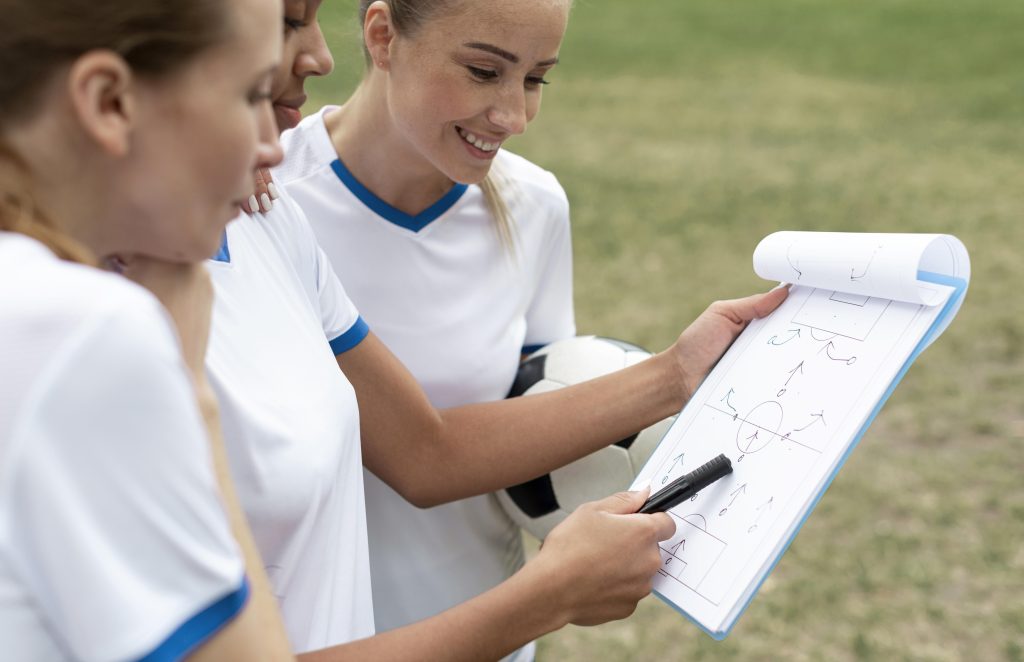 Teenage girls plan soccer play