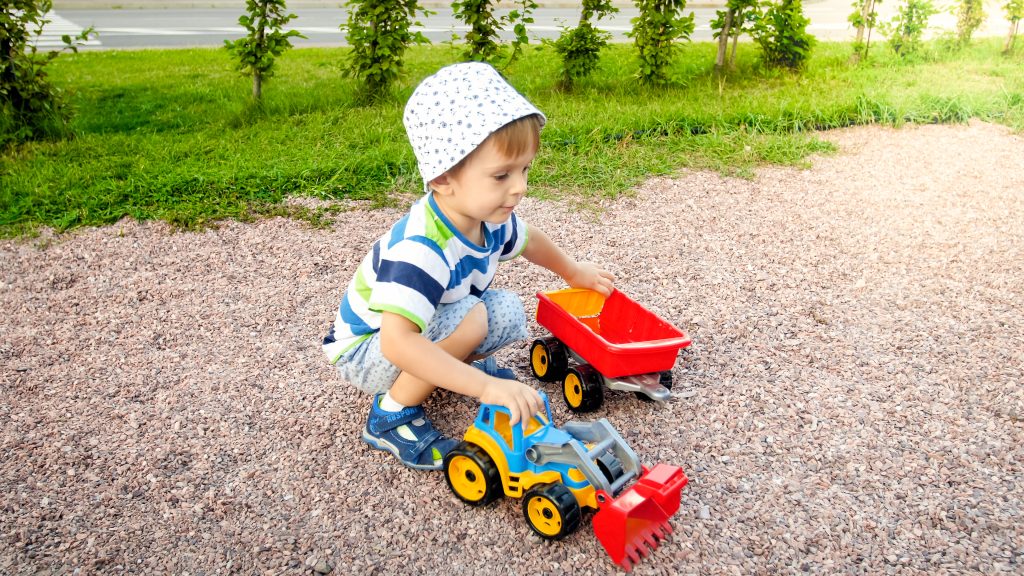 Young ADHD or autistic boy plays with diggers
