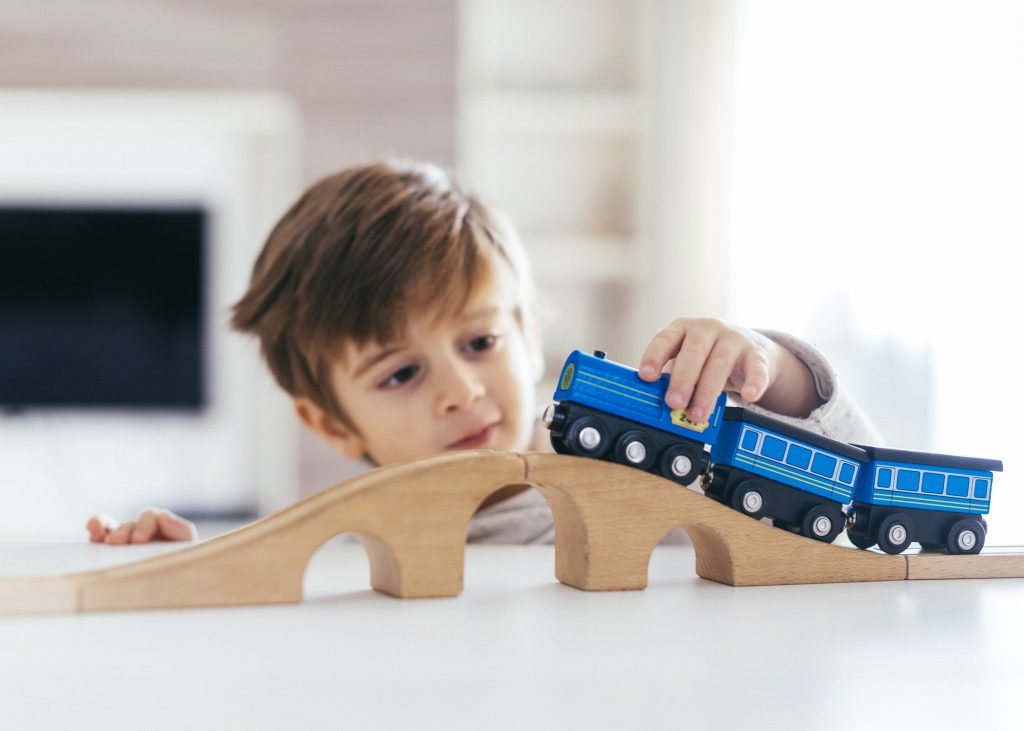 ADHD or autistic kid plays with trains