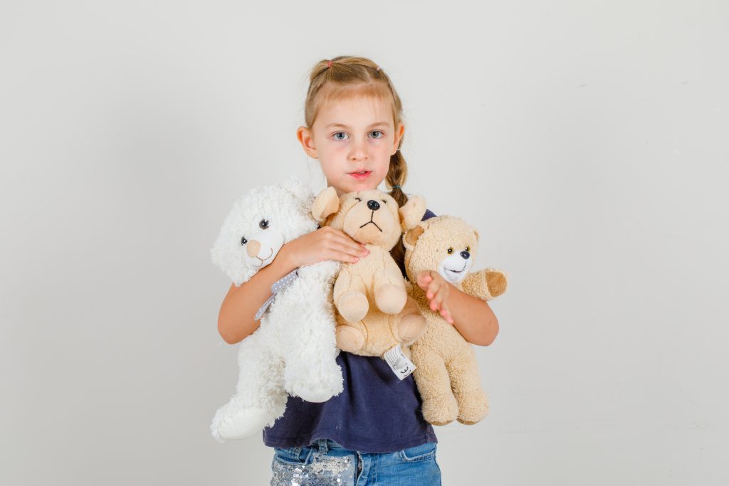 Young girl with stuffed animals
