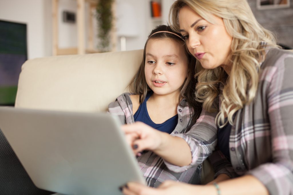 Mom and daughter do online learning together.