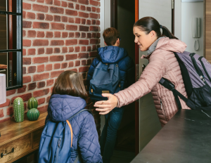 mom and two kids rushing out the door