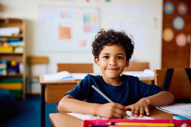 Smiling child at their homeschool desk